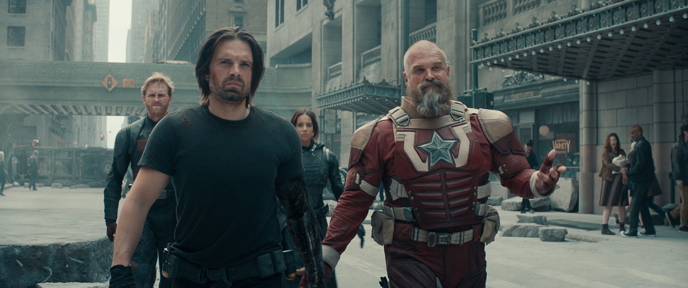 Bucky (Sebastian Stan), Red Guardian (David Harbour) and the other members of the Thunderbolts walk toward the camera on a rubble-strewn Manhattan street in Thunderbolts*